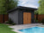 Sleek wooden shed by the pool with large double doors, perfect for storing pool equipment and outdoor gear