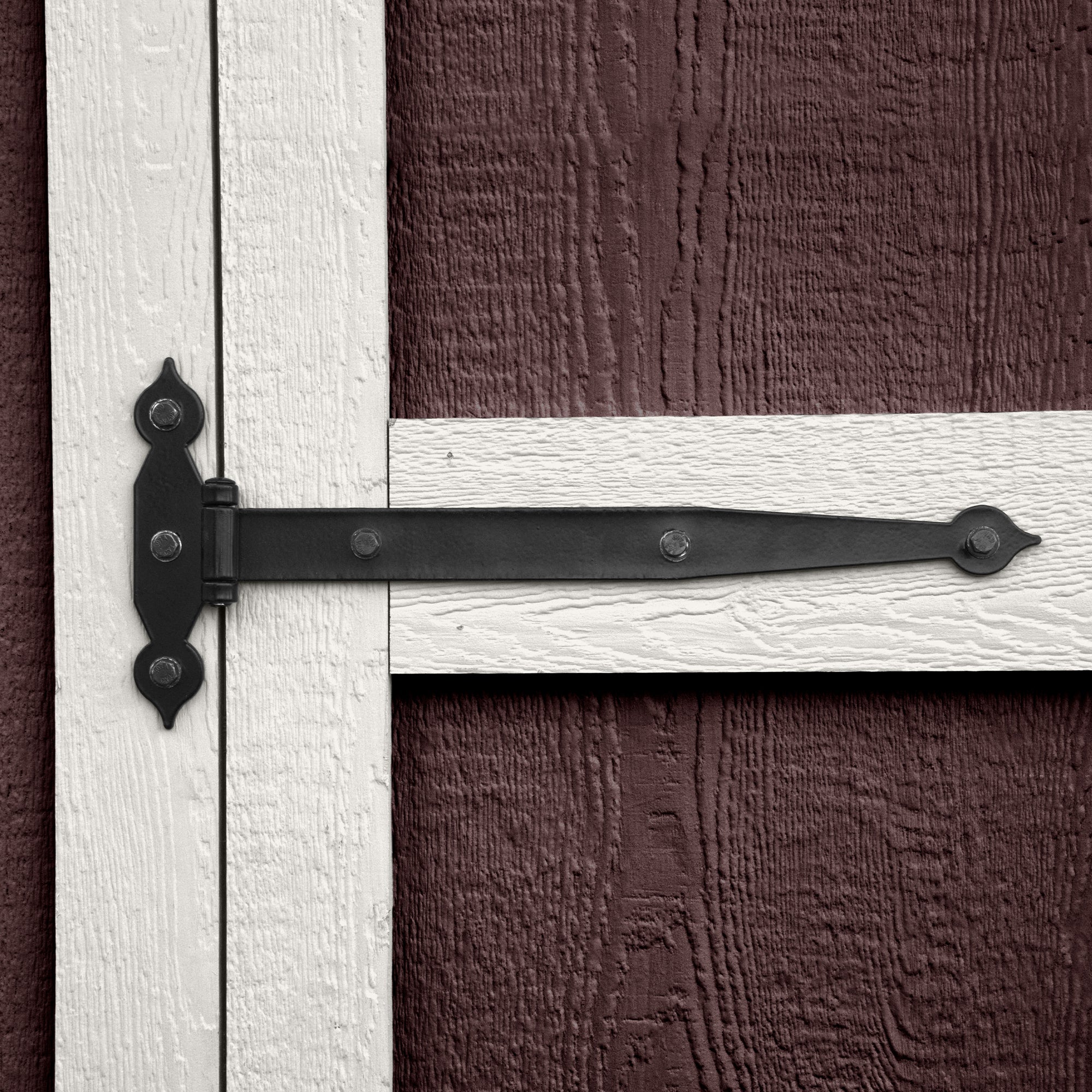 close up of the decorative hinges on the wood door