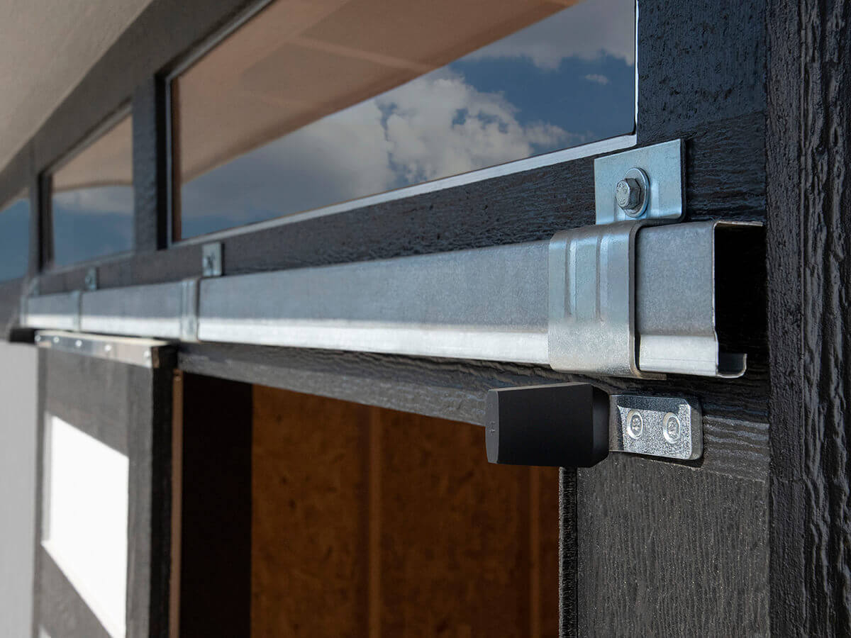 Close-up of sliding door hardware with metal track and locking mechanism for Contempo shed