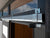 Close-up of sliding door hardware with metal track and locking mechanism for Contempo shed