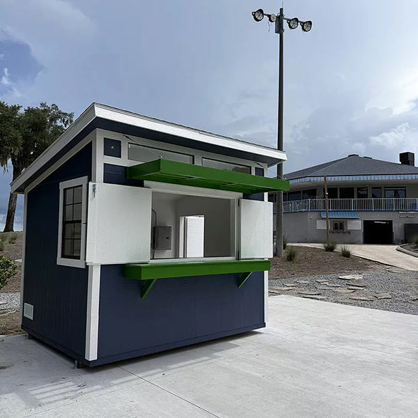 Small shed with a green and white canopy on a bar top surface.
