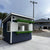 Small shed with a green and white canopy on a bar top surface.