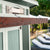 Close-up of the Pentwater Bar Shed's overhead pergola with a wooden beam and supporting cables for a stylish outdoor space